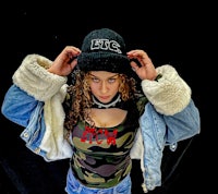 a woman wearing a camouflage hat and jacket