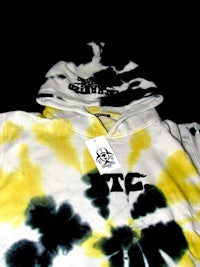 a tie dye hoodie with a tag on it