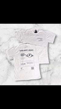 a white t - shirt with an eye on it