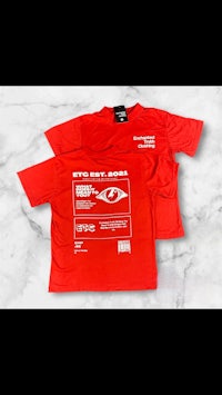 a red t - shirt with a white logo on it