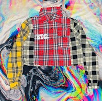 a shirt with a plaid pattern on top of a colorful background