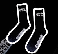 a pair of black socks with white letters on them