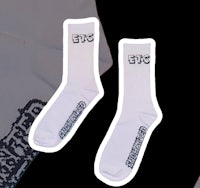 a pair of white socks with the words ecc on them